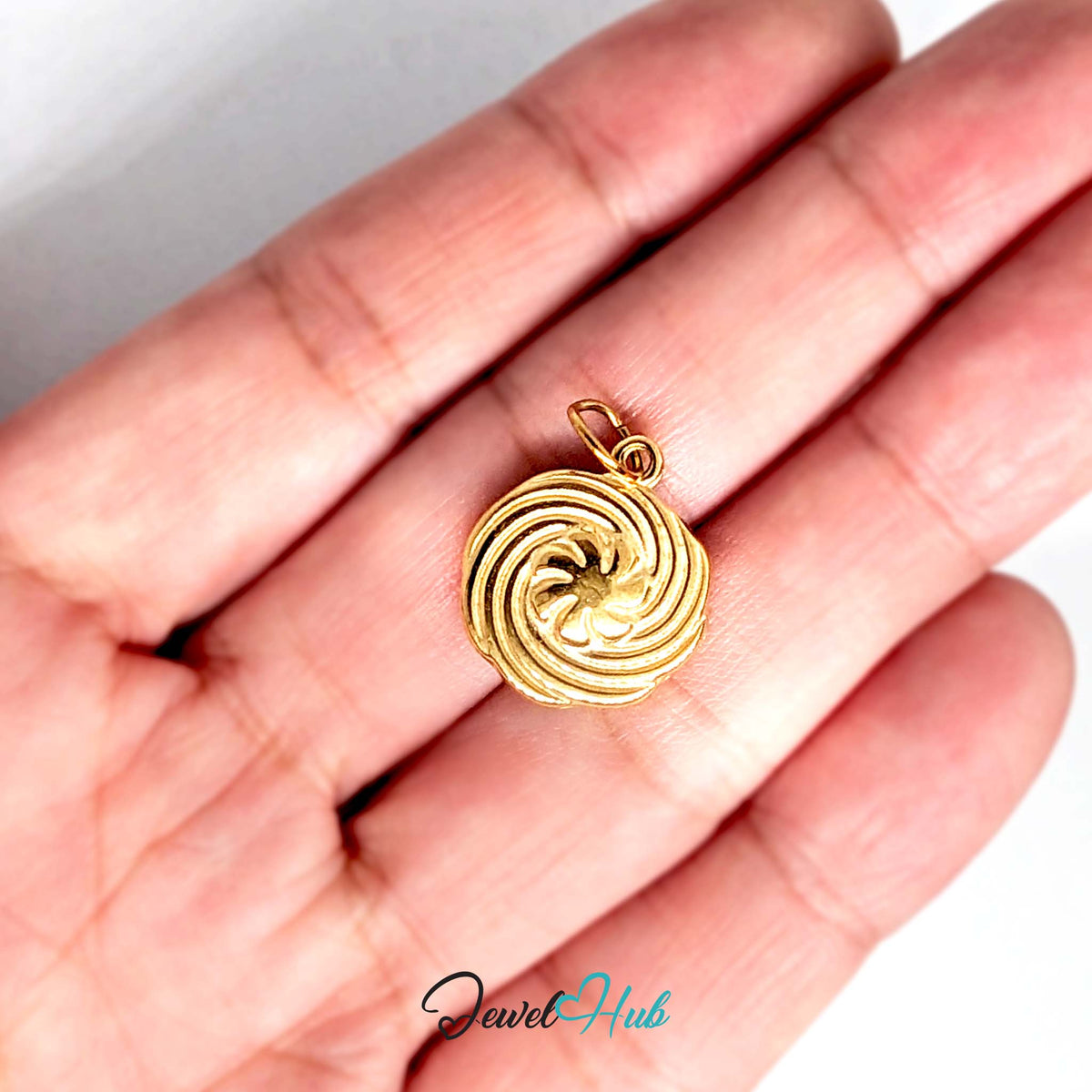 Swirl butter cookie charm held in a hand to show its size - JewelHub