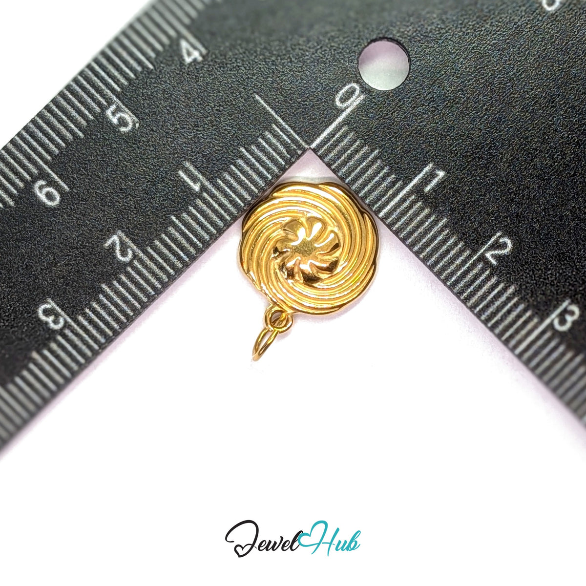 Swirl butter cookie charm measured against a ruler at 14.8mm wide by 17mm tall - JewelHub