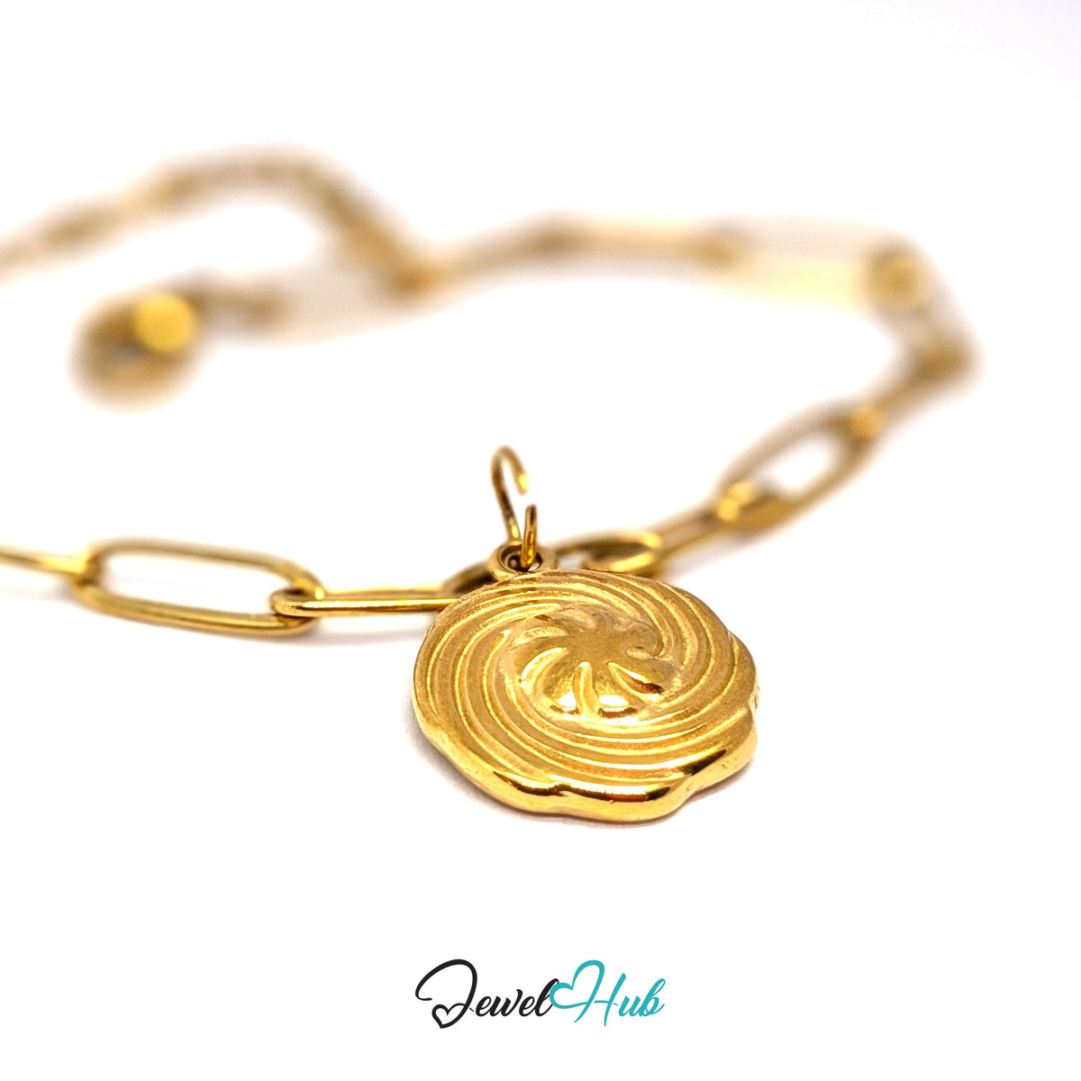 Gold-tone swirl butter cookie charm styled on a gold paperclip chain bracelet - JewelHub