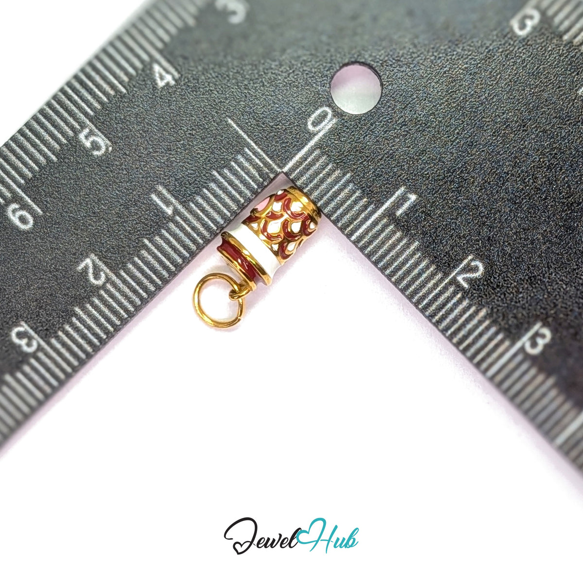 Heart patterned coffee cup charm measured against a ruler at 7.3mm wide by 13mm tall - JewelHub