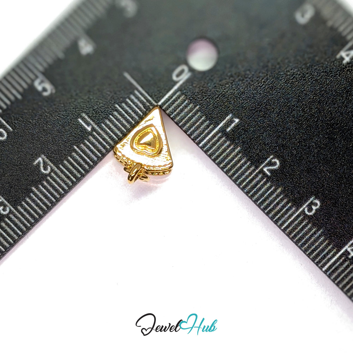 Layered cake slice charm measured against a ruler at 10.5mm wide by 11.1mm tall - JewelHub