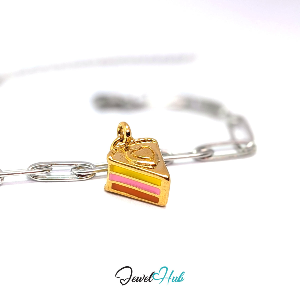 Gold-tone layered cake slice charm styled on a silver paperclip chain bracelet for a two-tone look - JewelHub