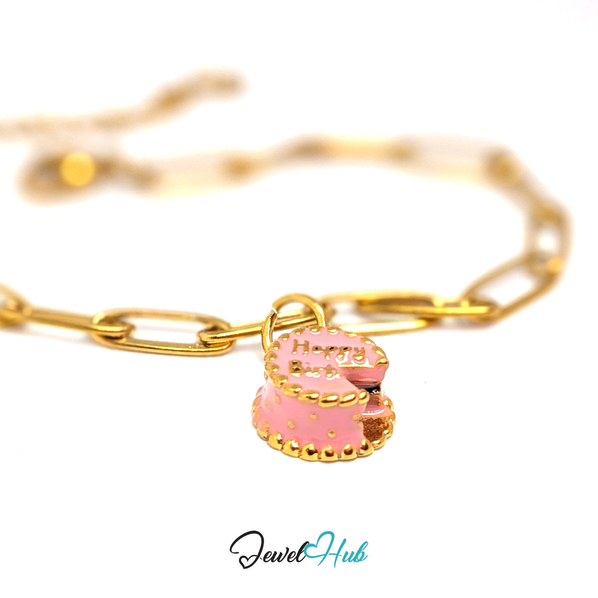 Gold-tone pink birthday cake charm styled on a gold paperclip chain bracelet - JewelHub