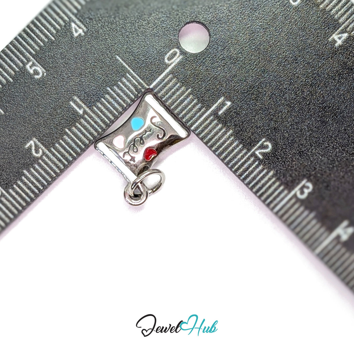 Sweet candy wrapper charm measured against a ruler at 13.6mm wide by 16.5mm tall - JewelHub