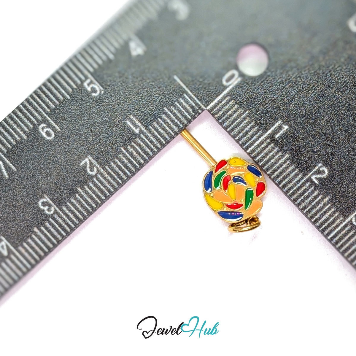 Rainbow swirl lollipop charm measured against a ruler at 11mm wide by 20.5mm tall - JewelHub