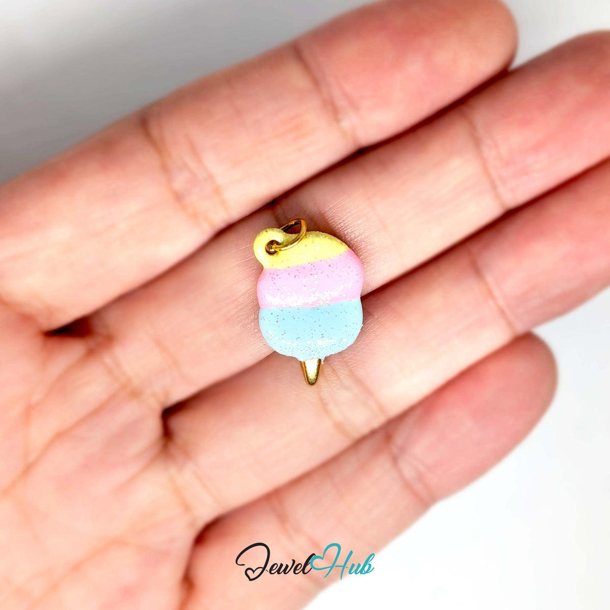 Pastel glitter cotton candy charm held in a hand to show its size - JewelHub