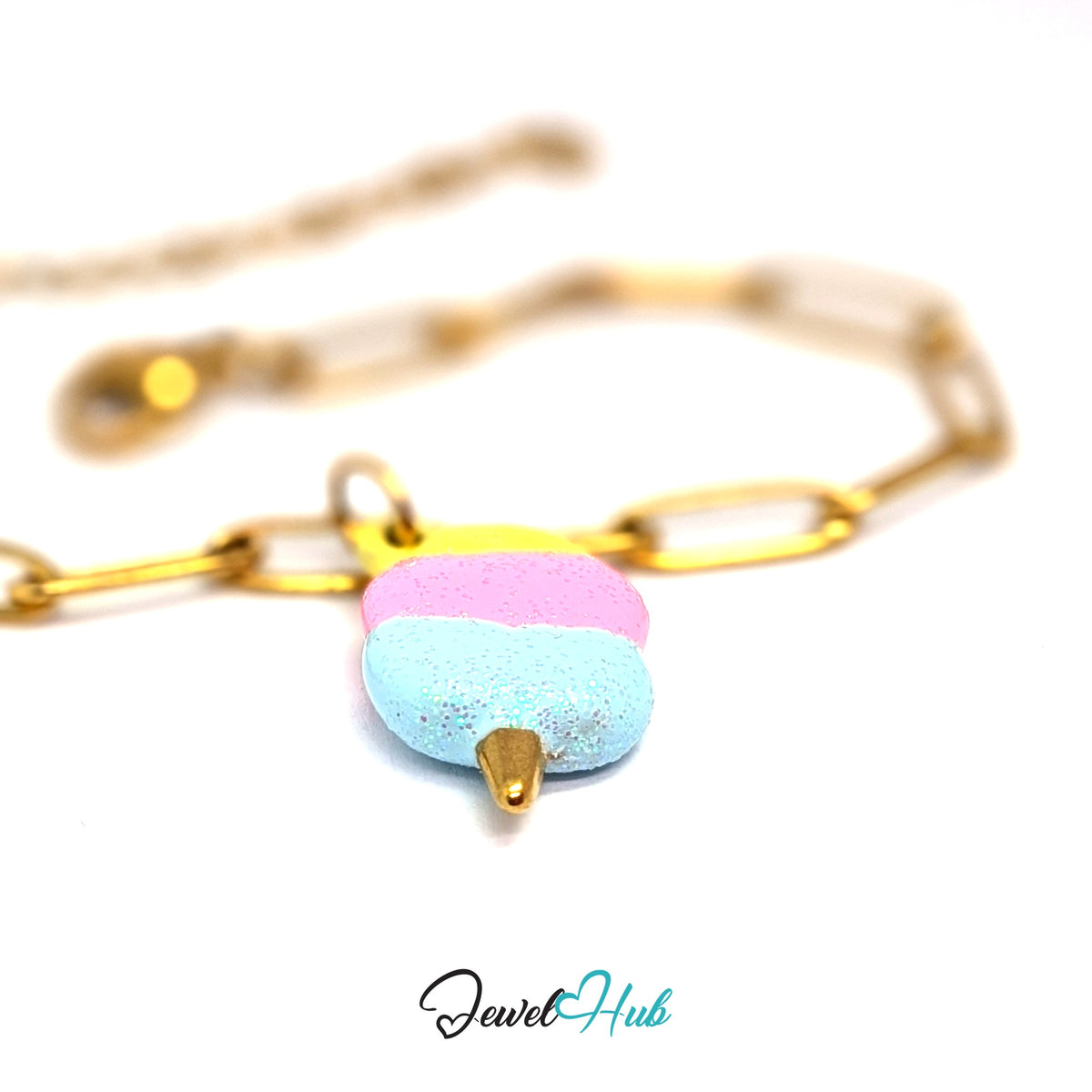 Gold-tone pastel glitter cotton candy charm styled on a gold paperclip chain bracelet - JewelHub