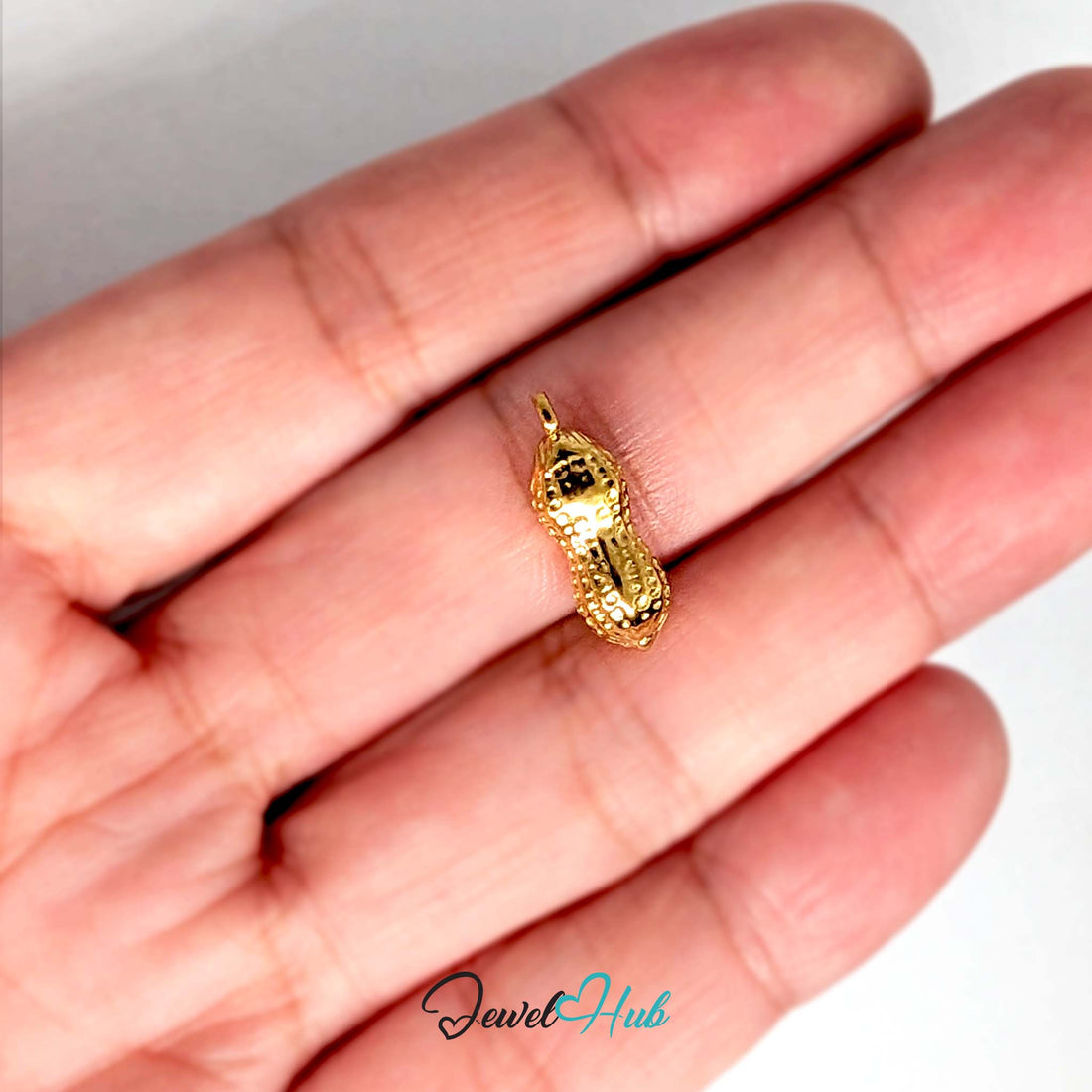 Dotted peanut charm in gold-tone stainless steel - JewelHub