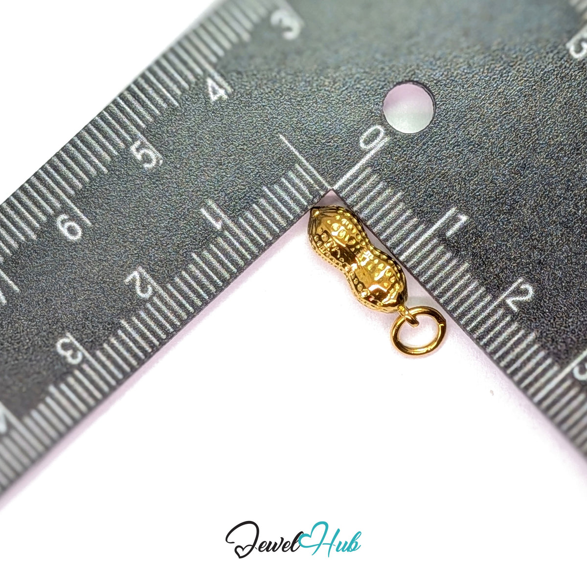 Dotted peanut charm measured against a ruler at 5.8mm wide by 16.5mm tall - JewelHub