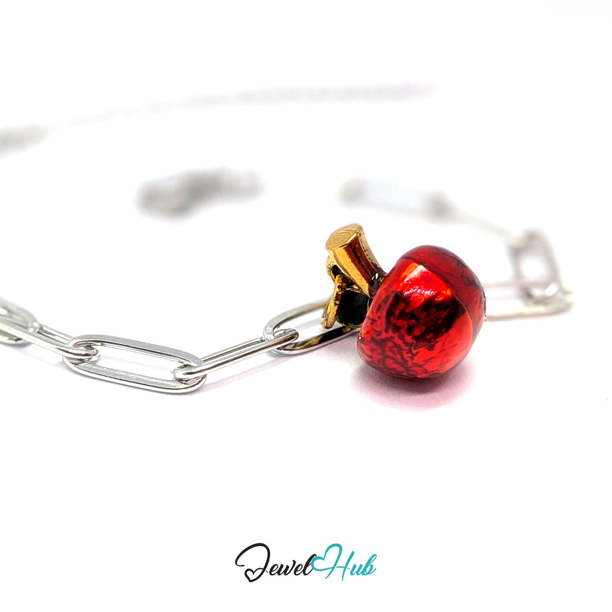 Gold-tone red apple charm styled on a silver paperclip chain bracelet for a two-tone look - JewelHub