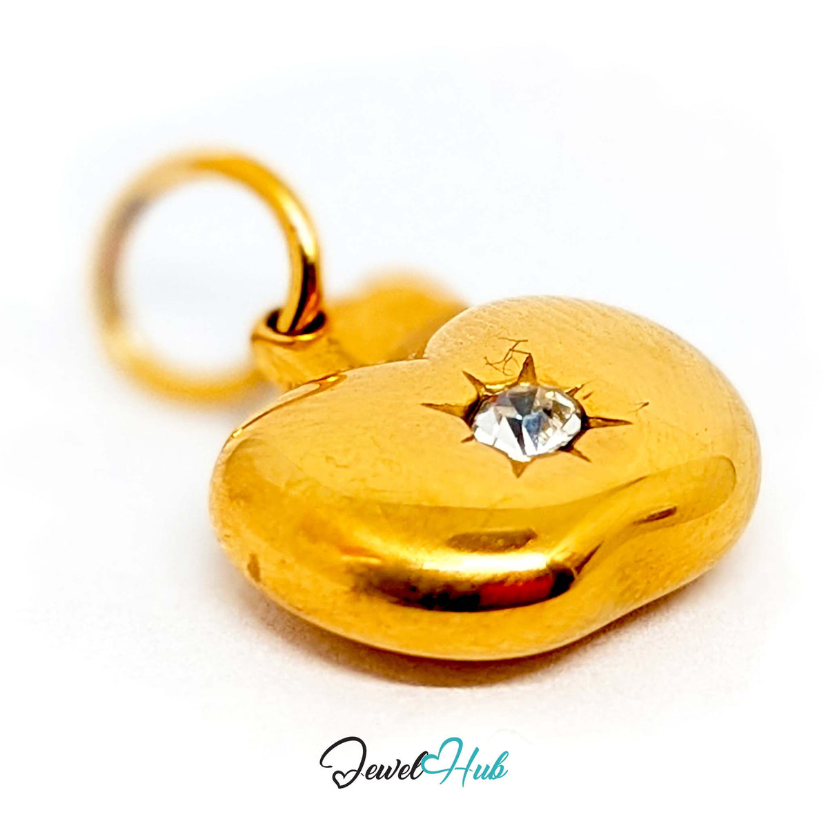 Close-up of the gold-tone crystal apple charm detail - JewelHub