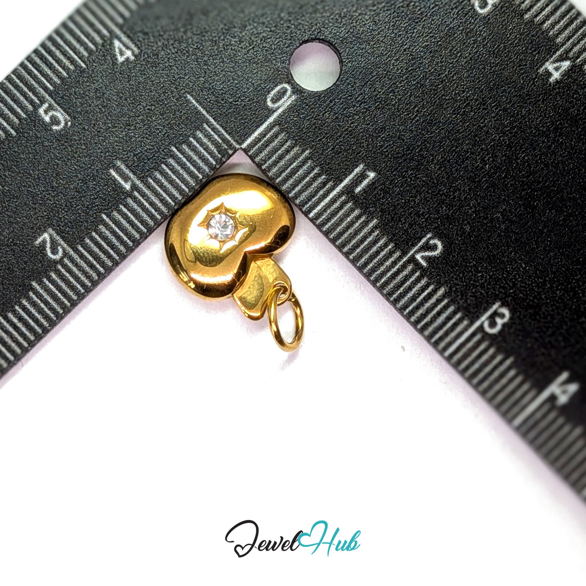 Crystal apple charm measured against a ruler at 14.3mm wide by 14.8mm tall - JewelHub