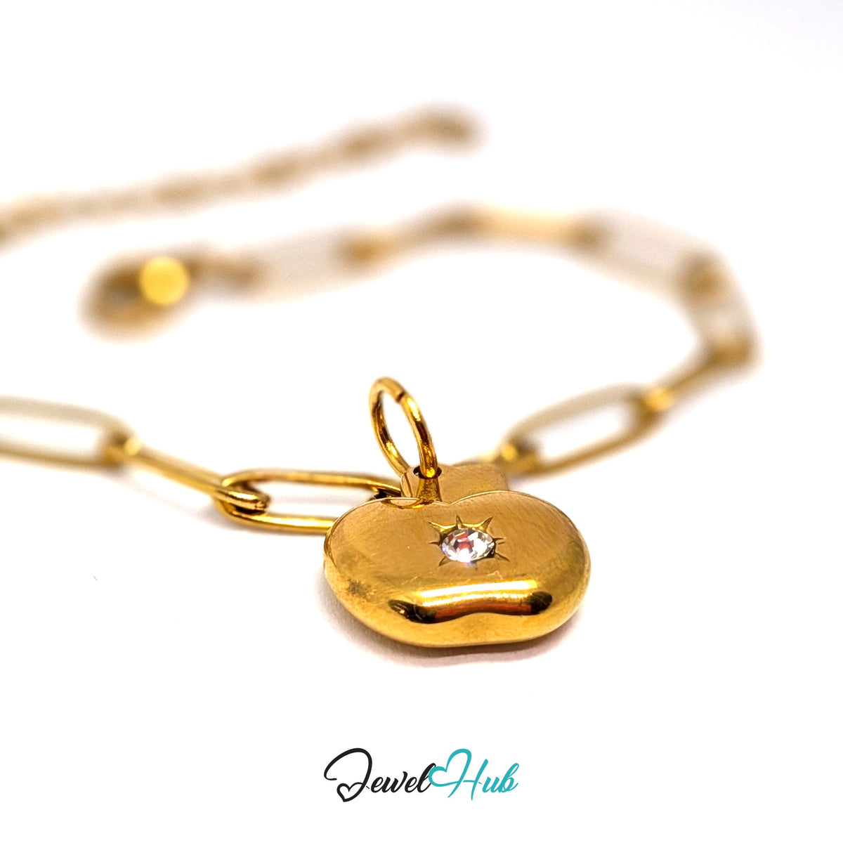 Gold-tone crystal apple charm styled on a gold paperclip chain bracelet - JewelHub