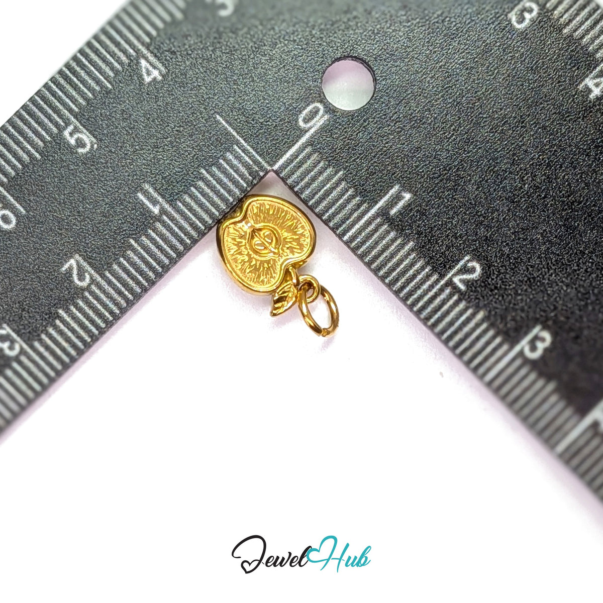 Apple half charm measured against a ruler at 10mm wide by 12.6mm tall - JewelHub
