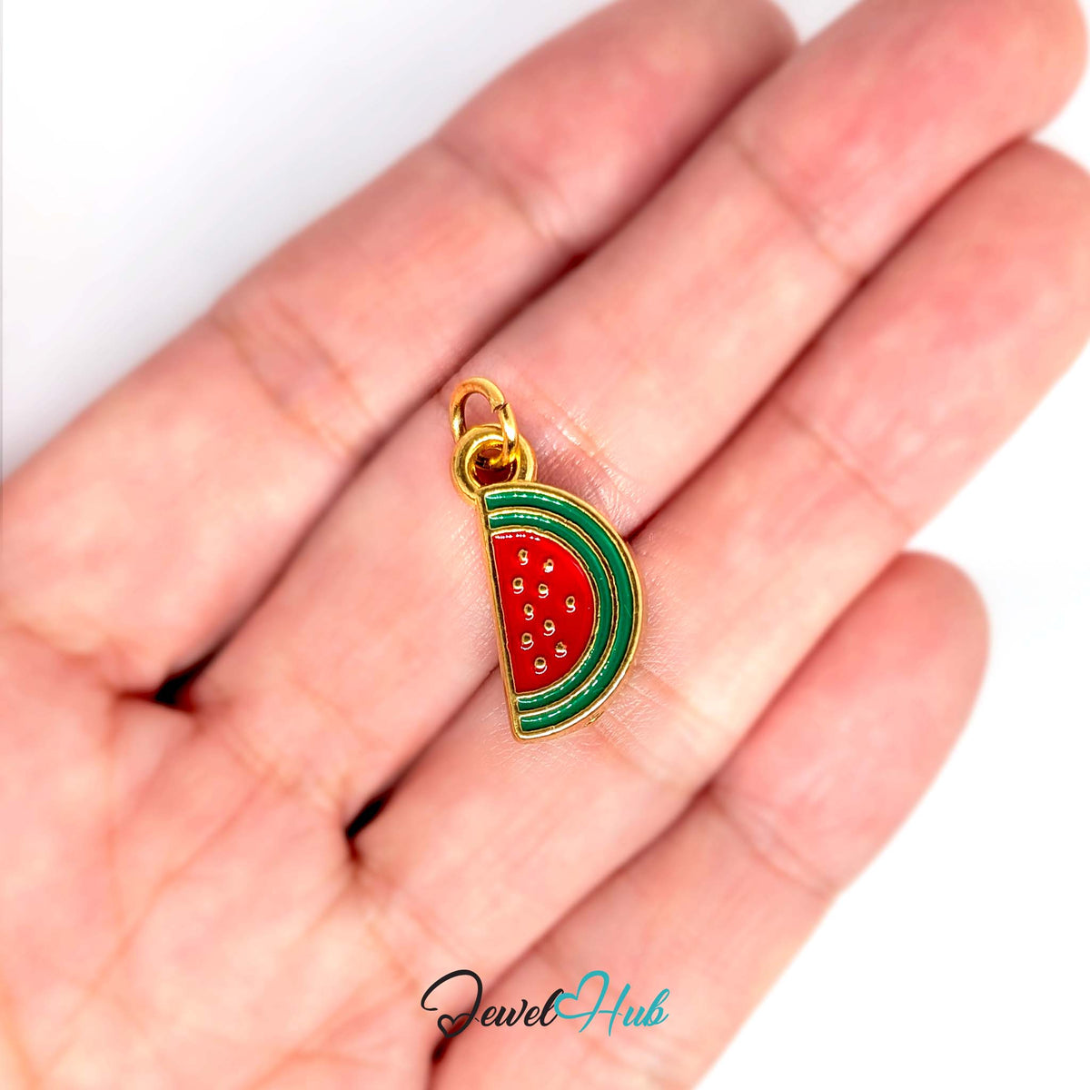 Watermelon slice charm held in a hand to show its size - JewelHub