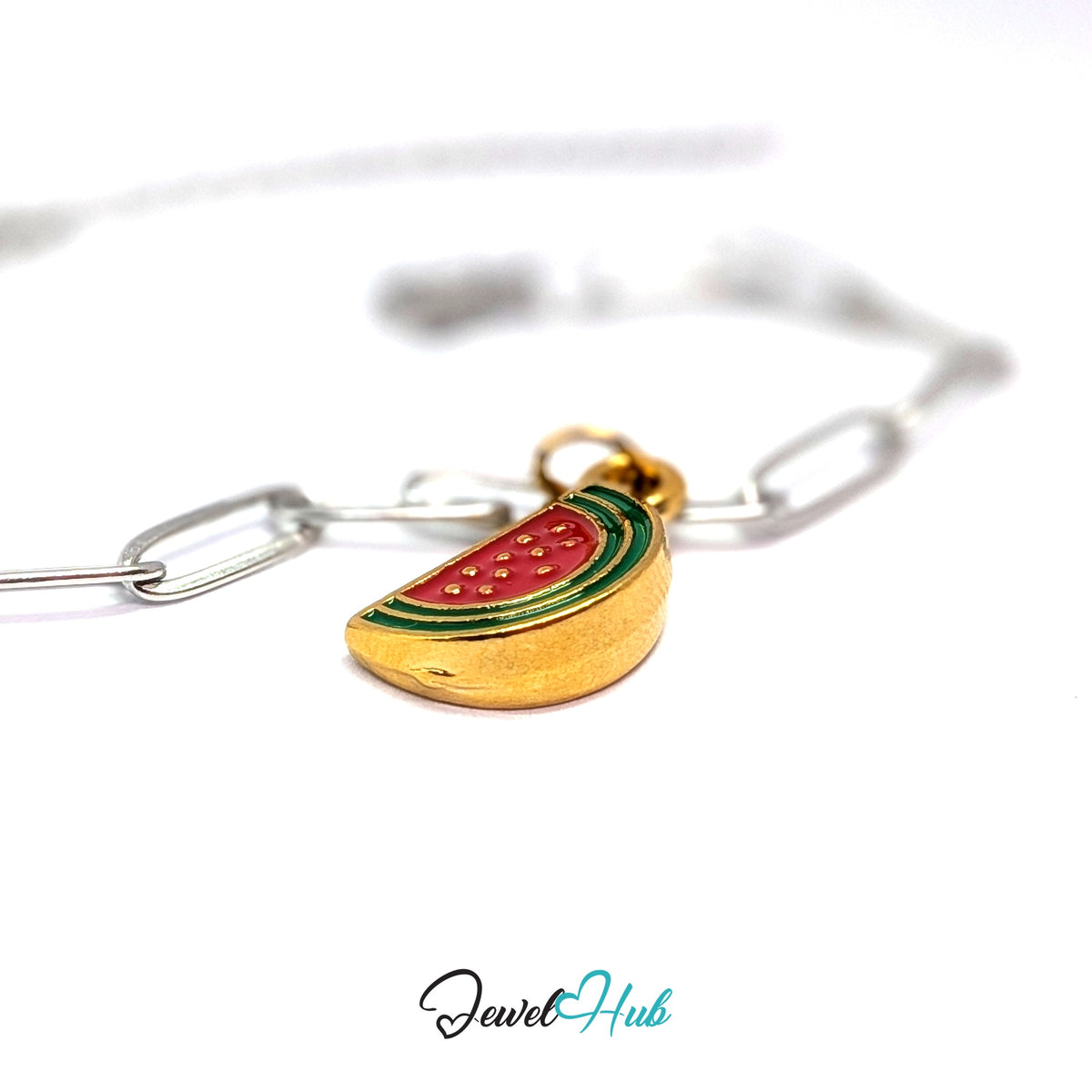 Gold-tone watermelon slice charm styled on a silver paperclip chain bracelet for a two-tone look - JewelHub