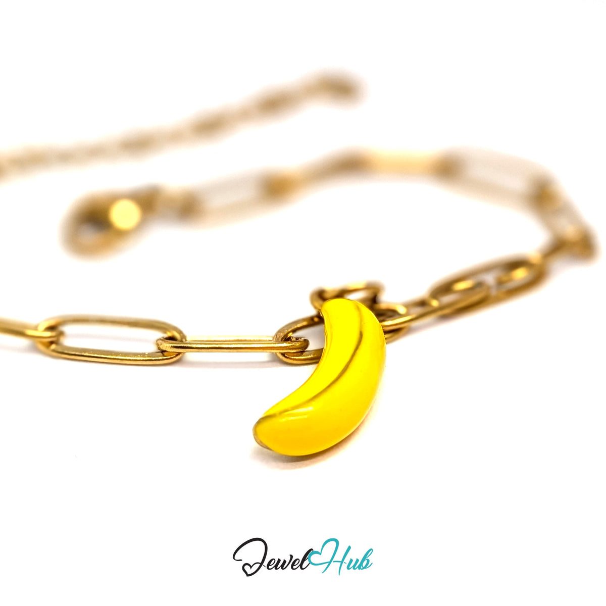Gold-tone yellow enamel banana charm styled on a gold paperclip chain bracelet - JewelHub