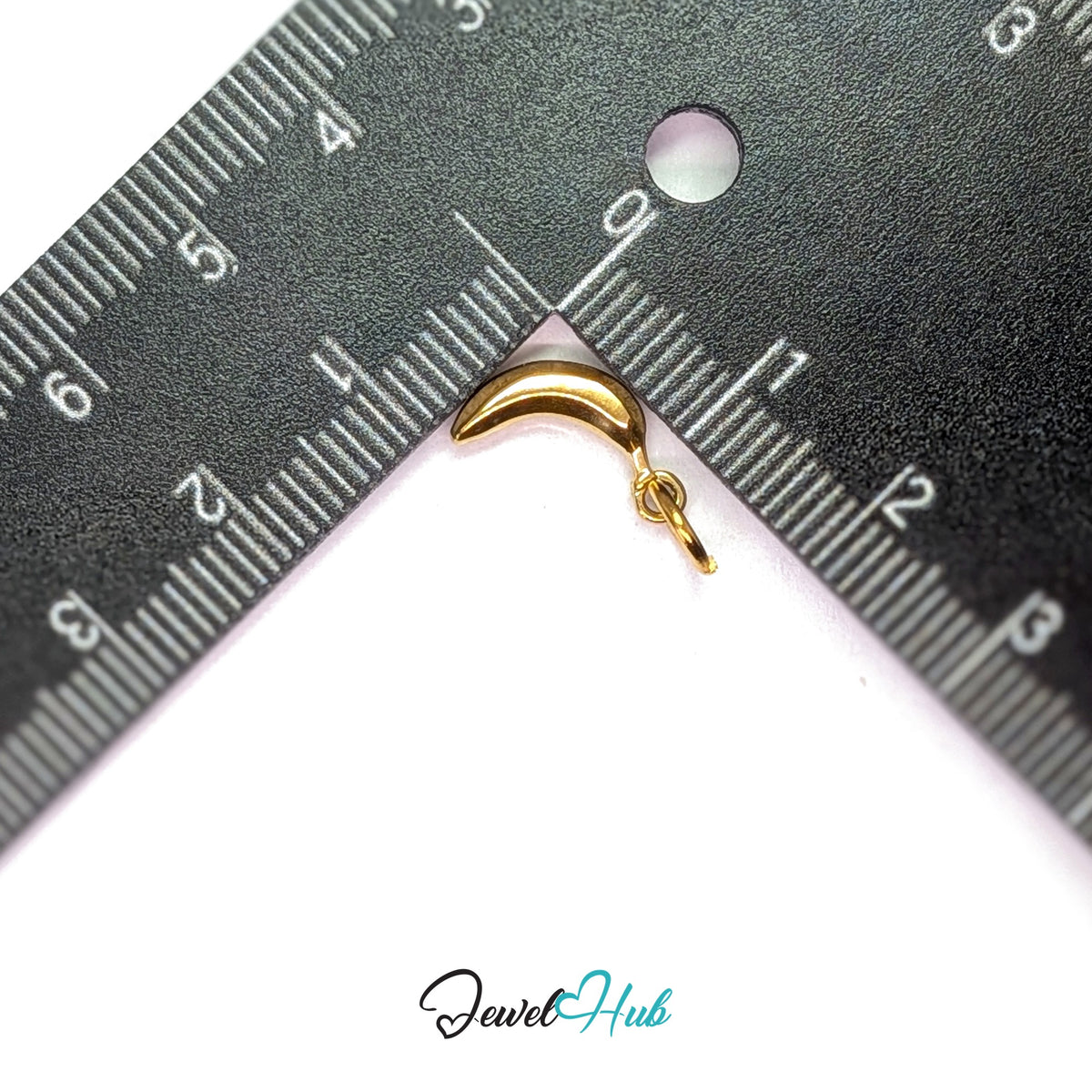 Polished banana charm measured against a ruler at 6.2mm wide by 13.8mm tall - JewelHub