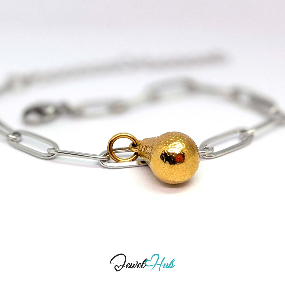 Gold-tone hammered pear charm styled on a silver paperclip chain bracelet for a two-tone look - JewelHub