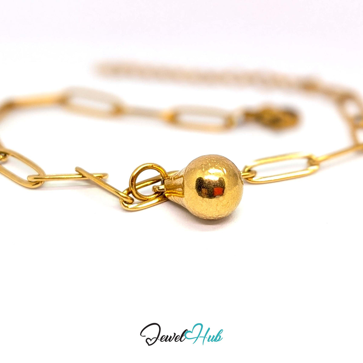 Gold-tone hammered pear charm styled on a gold paperclip chain bracelet - JewelHub