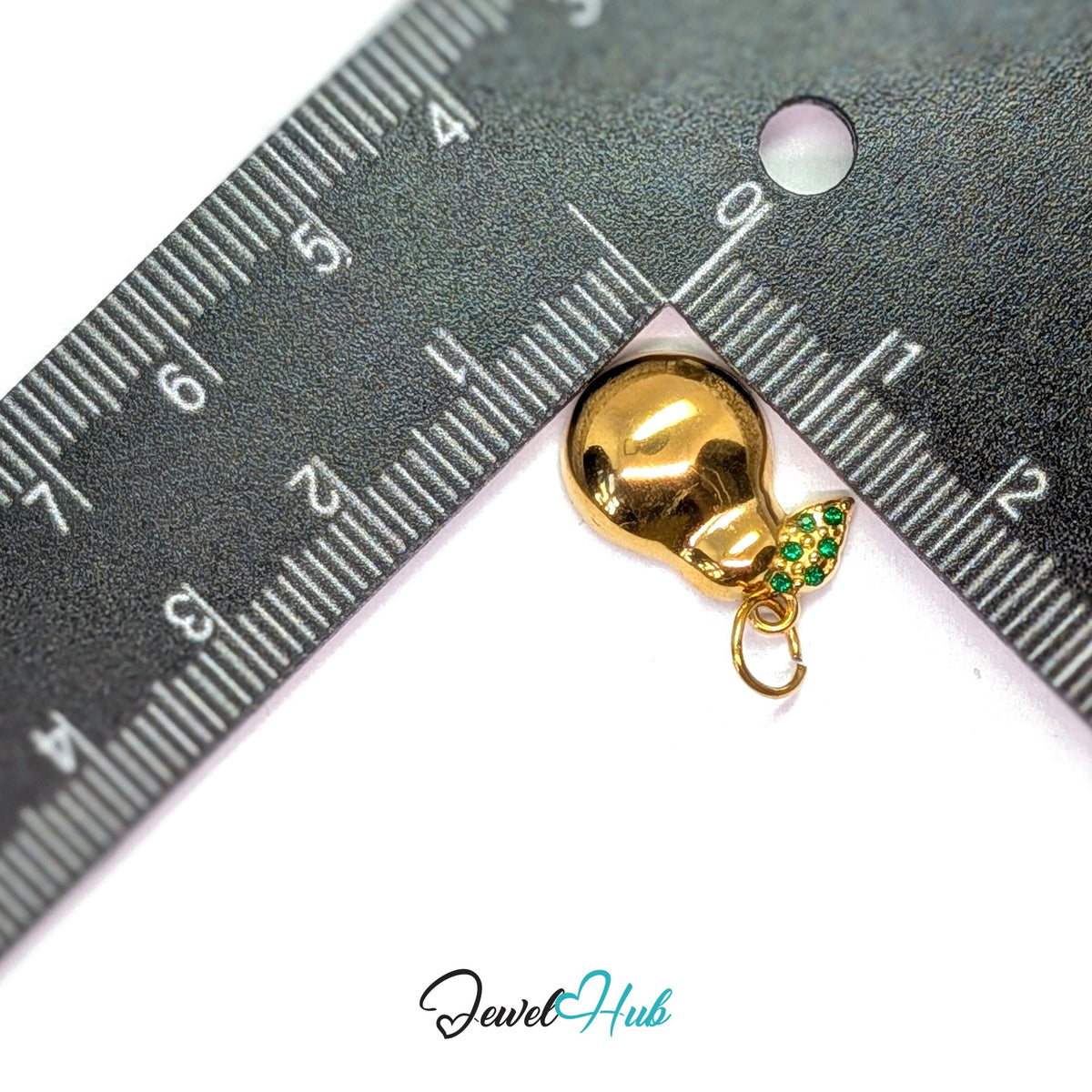 Crystal leaf pear charm measured against a ruler at 12mm wide by 18mm tall - JewelHub
