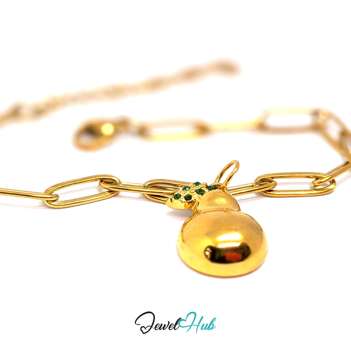 Gold-tone crystal leaf pear charm styled on a gold paperclip chain bracelet - JewelHub