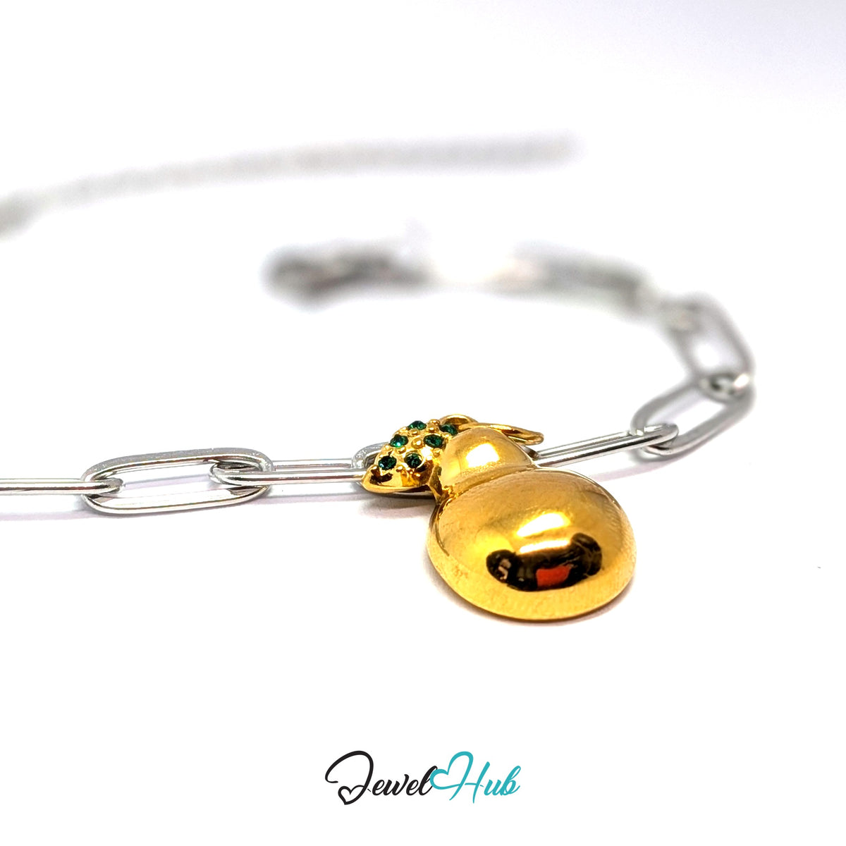 Gold-tone crystal leaf pear charm styled on a silver paperclip chain bracelet for a two-tone look - JewelHub