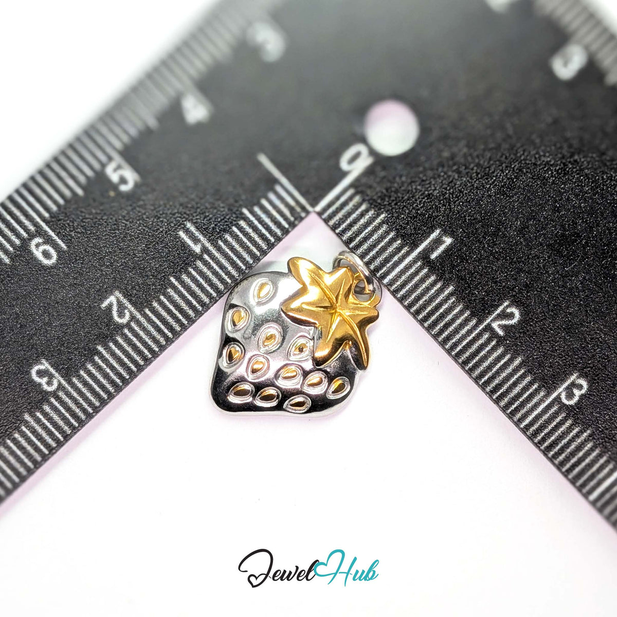 Two-tone strawberry charm measured against a ruler at 16.5mm wide by 21mm tall - JewelHub