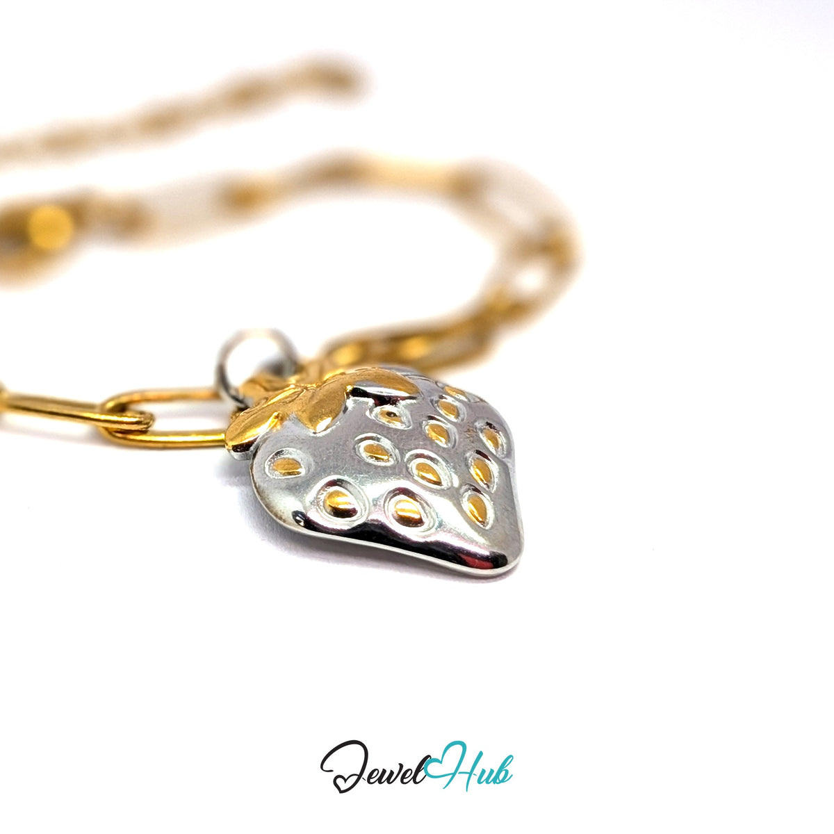Silver-tone two-tone strawberry charm styled on a gold paperclip chain bracelet for a two-tone look - JewelHub