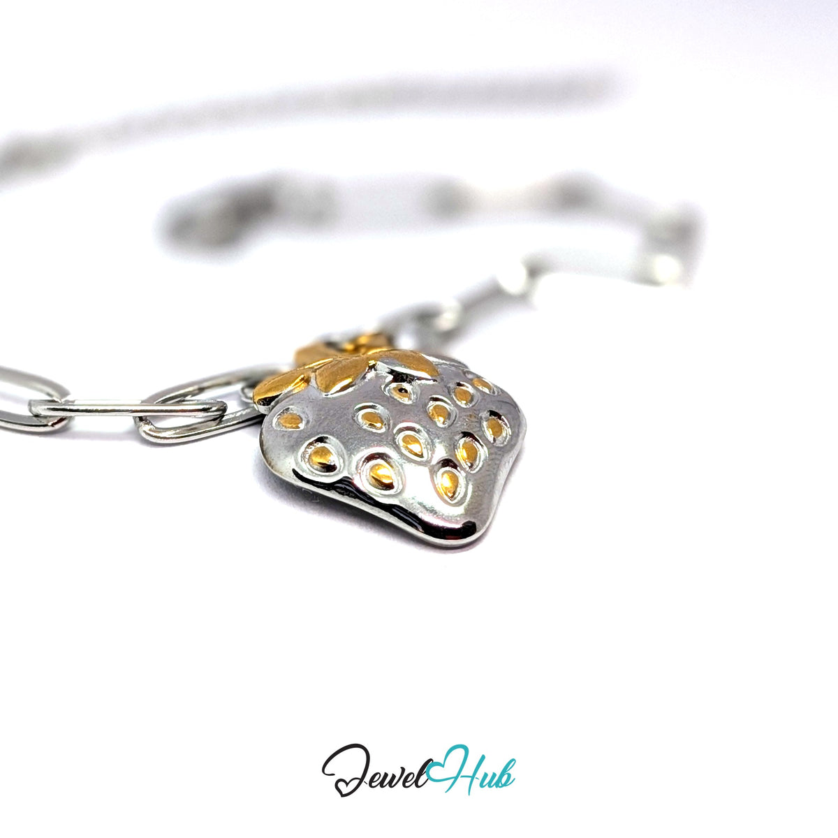 Silver-tone two-tone strawberry charm styled on a silver paperclip chain bracelet - JewelHub