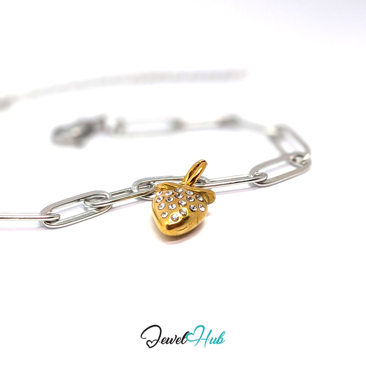 Gold-tone crystal strawberry charm styled on a silver paperclip chain bracelet for a two-tone look - JewelHub