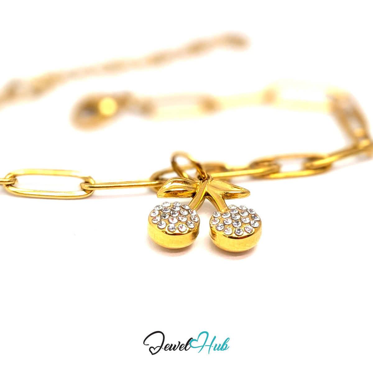 Gold-tone crystal cherry charm styled on a gold paperclip chain bracelet - JewelHub