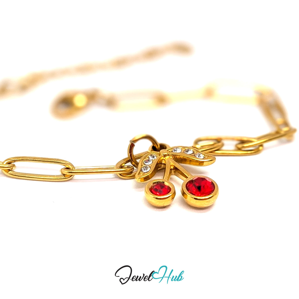 Gold-tone red gem cherry charm styled on a gold paperclip chain bracelet - JewelHub