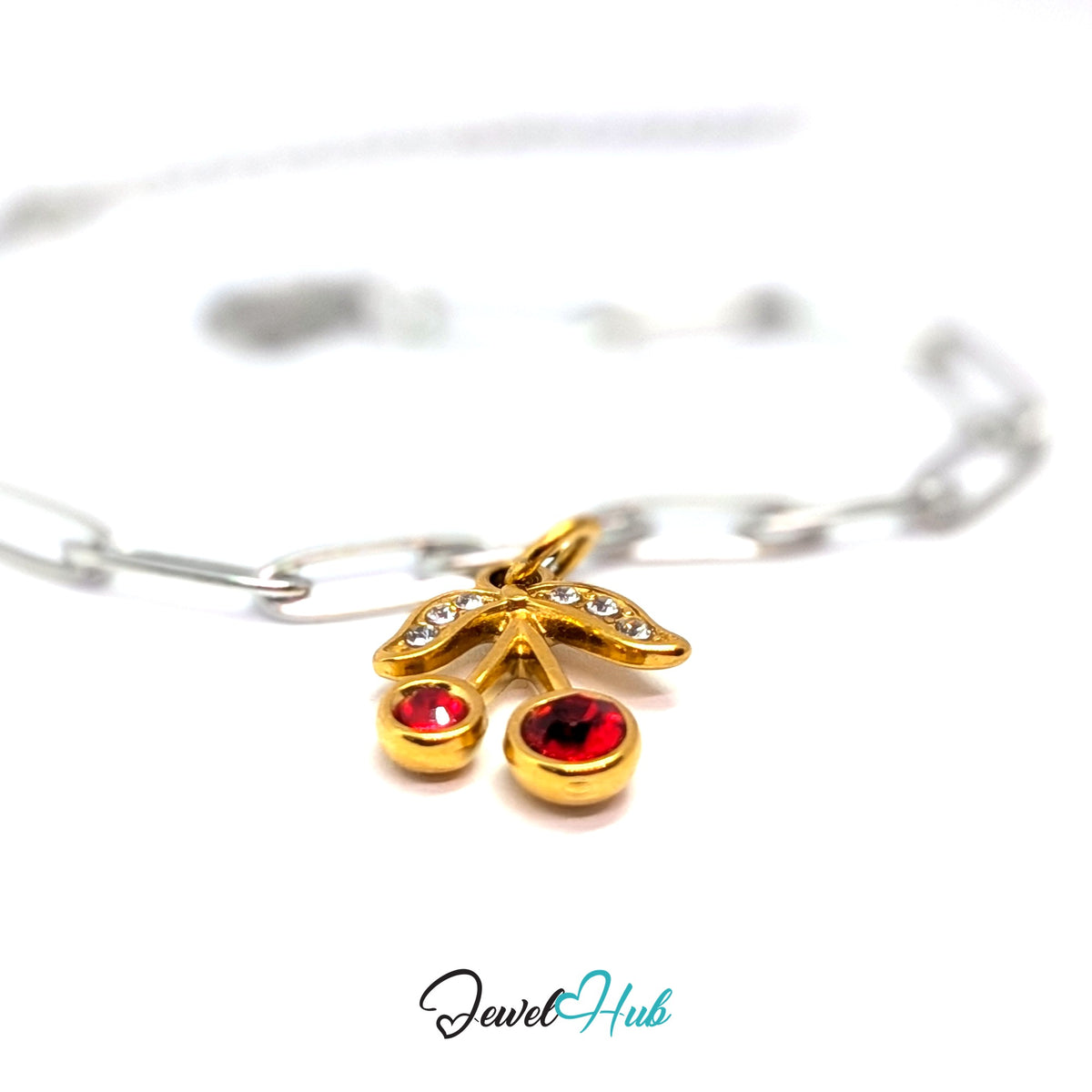 Gold-tone red gem cherry charm styled on a silver paperclip chain bracelet for a two-tone look - JewelHub