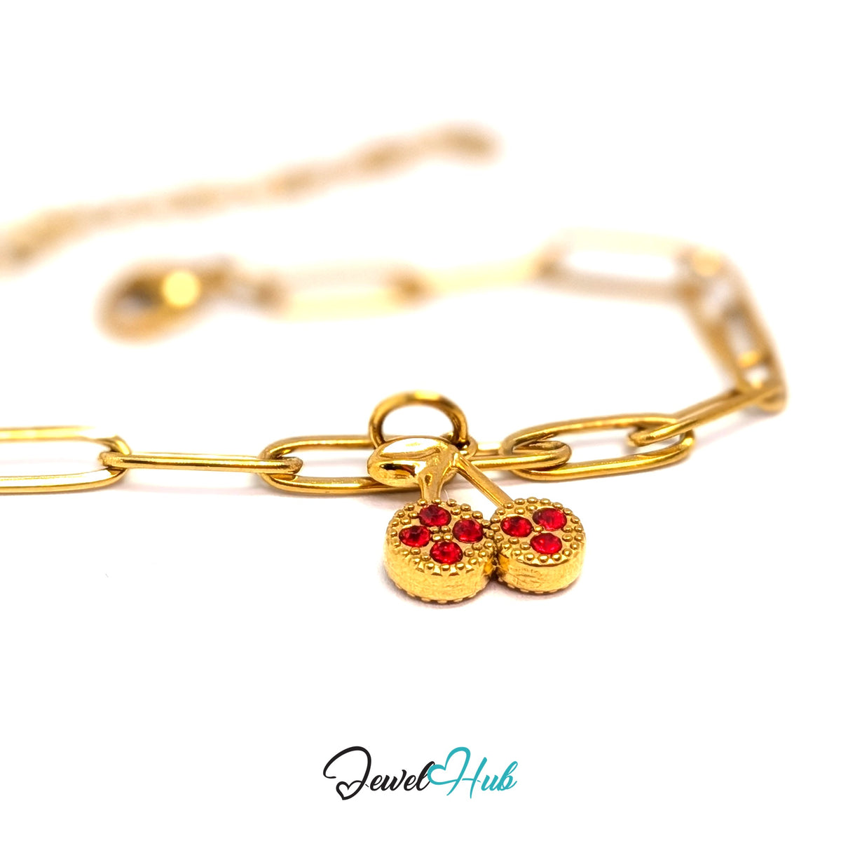 Gold-tone red stone cluster cherry charm styled on a gold paperclip chain bracelet - JewelHub
