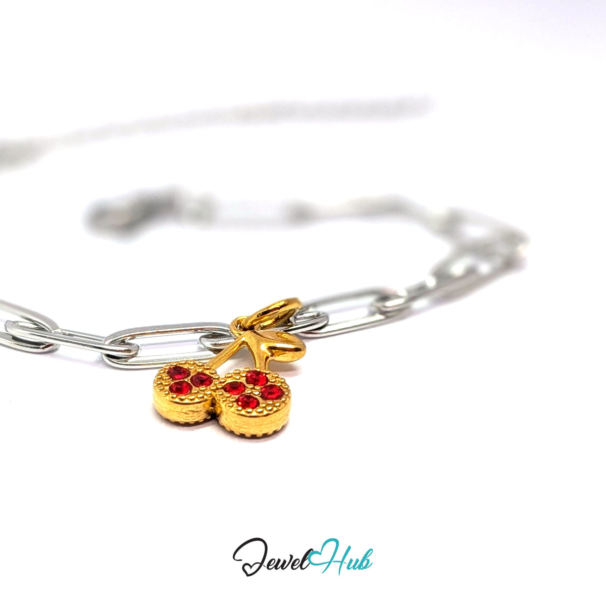 Gold-tone red stone cluster cherry charm styled on a silver paperclip chain bracelet for a two-tone look - JewelHub