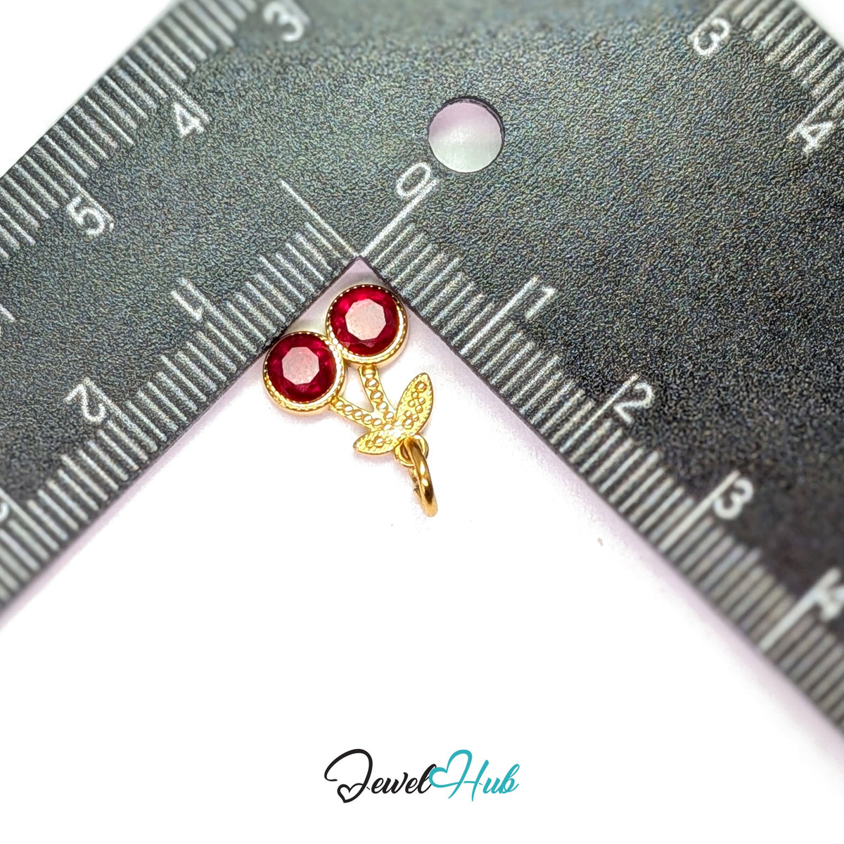 Big red gem cherry charm measured against a ruler at 11.8mm wide by 13.5mm tall - JewelHub