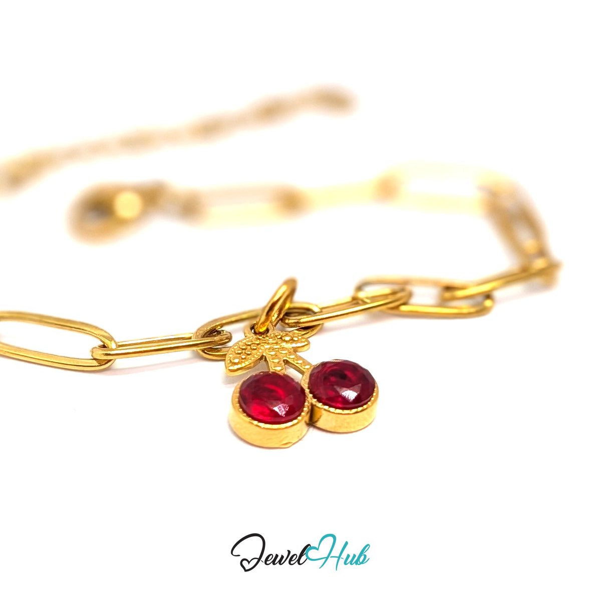 Gold-tone big red gem cherry charm styled on a gold paperclip chain bracelet - JewelHub