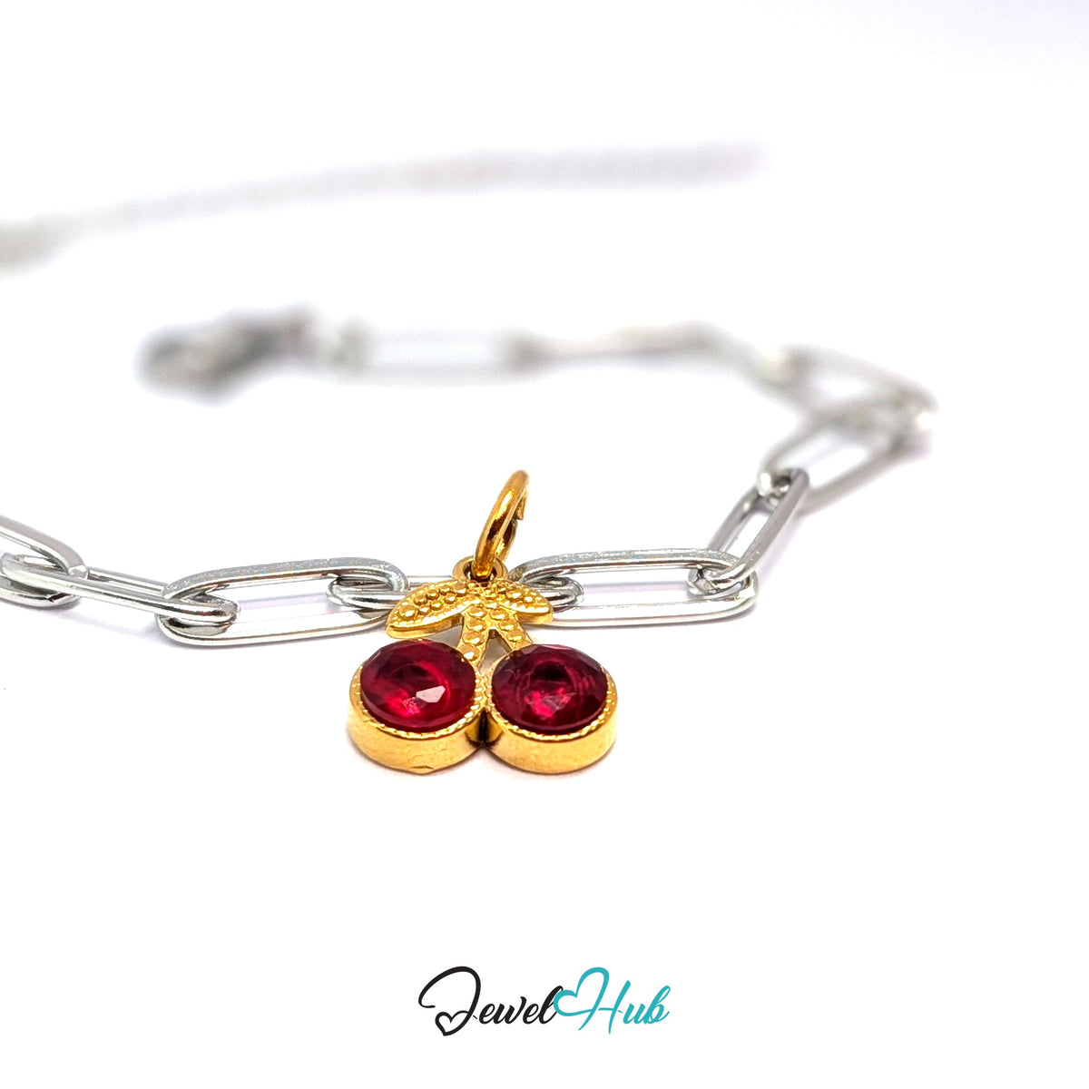 Gold-tone big red gem cherry charm styled on a silver paperclip chain bracelet for a two-tone look - JewelHub