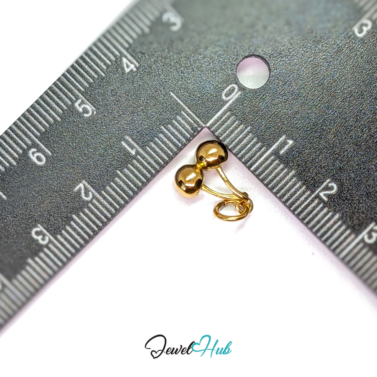 Polished cherry charm measured against a ruler at 10.5mm wide by 13.5mm tall - JewelHub