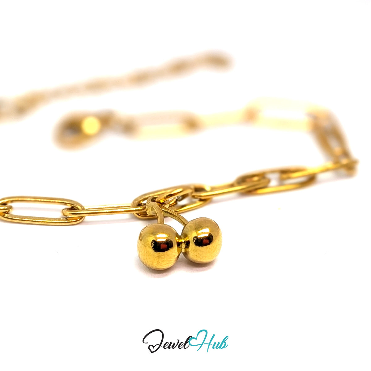 Gold-tone polished cherry charm styled on a gold paperclip chain bracelet - JewelHub