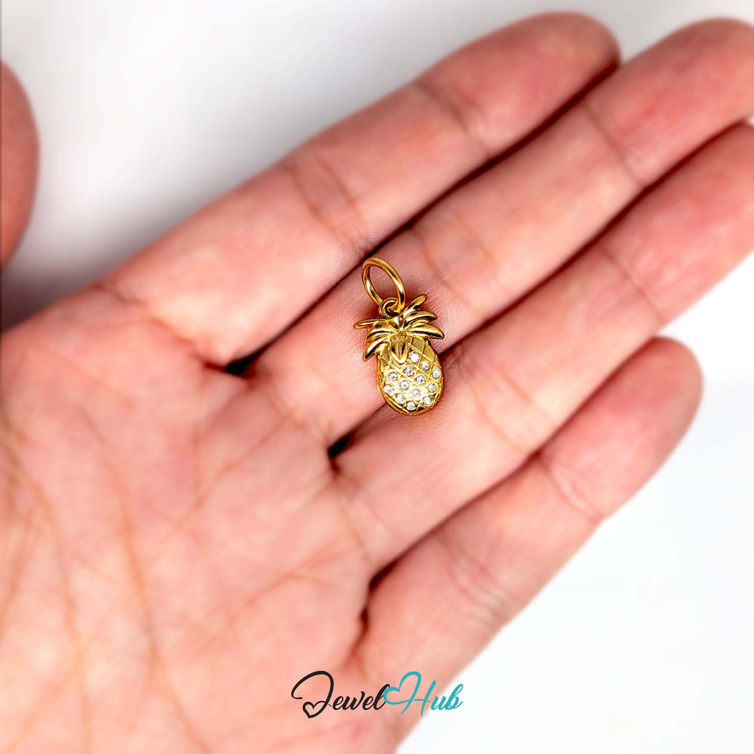 Crystal pineapple charm in gold-tone stainless steel, with clear glue-set crystals - JewelHub