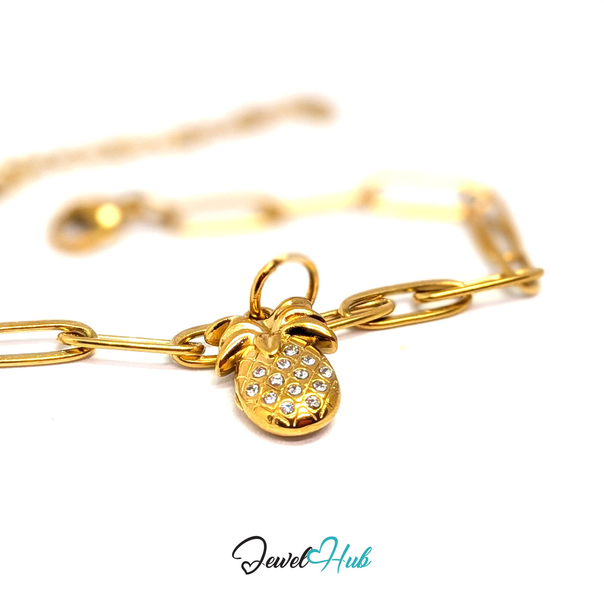 Gold-tone crystal pineapple charm styled on a gold paperclip chain bracelet - JewelHub