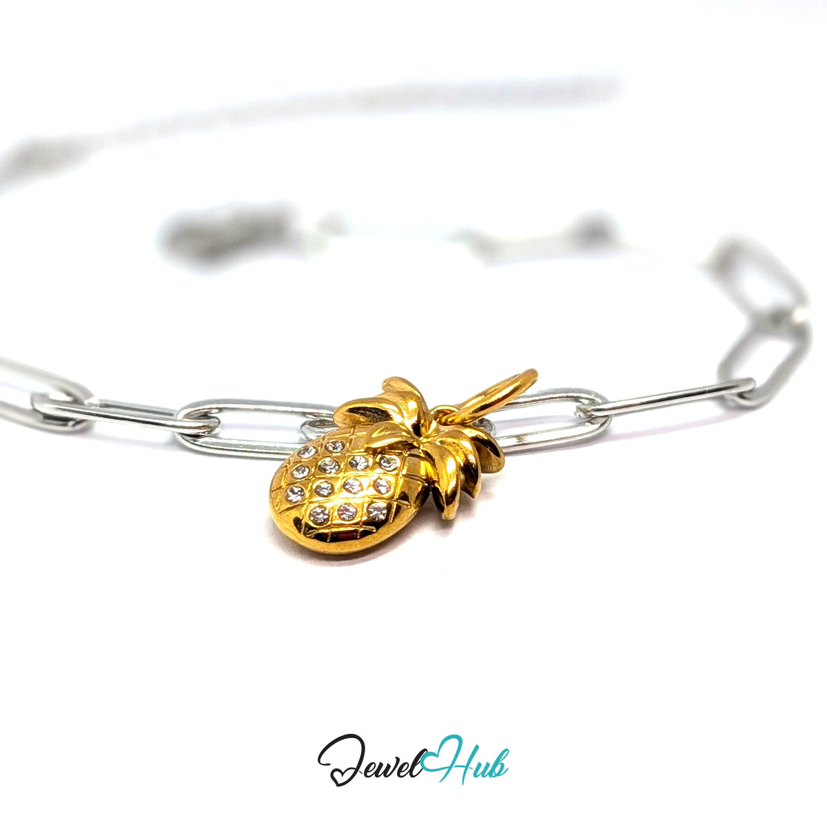 Gold-tone crystal pineapple charm styled on a silver paperclip chain bracelet for a two-tone look - JewelHub