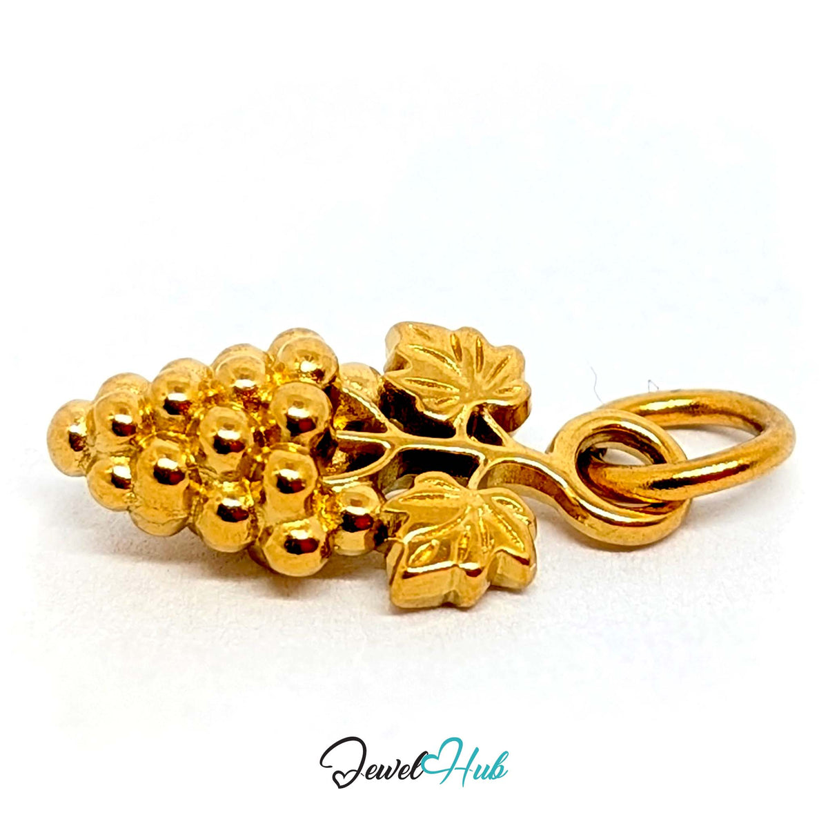 Angled view of the gold-tone grape bunch with leaves charm - JewelHub