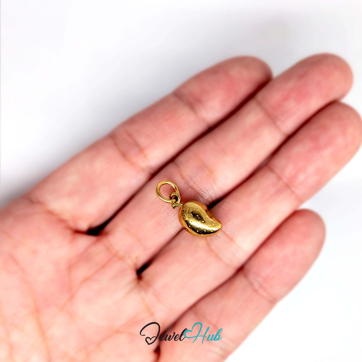Mango charm held in a hand to show its size - JewelHub