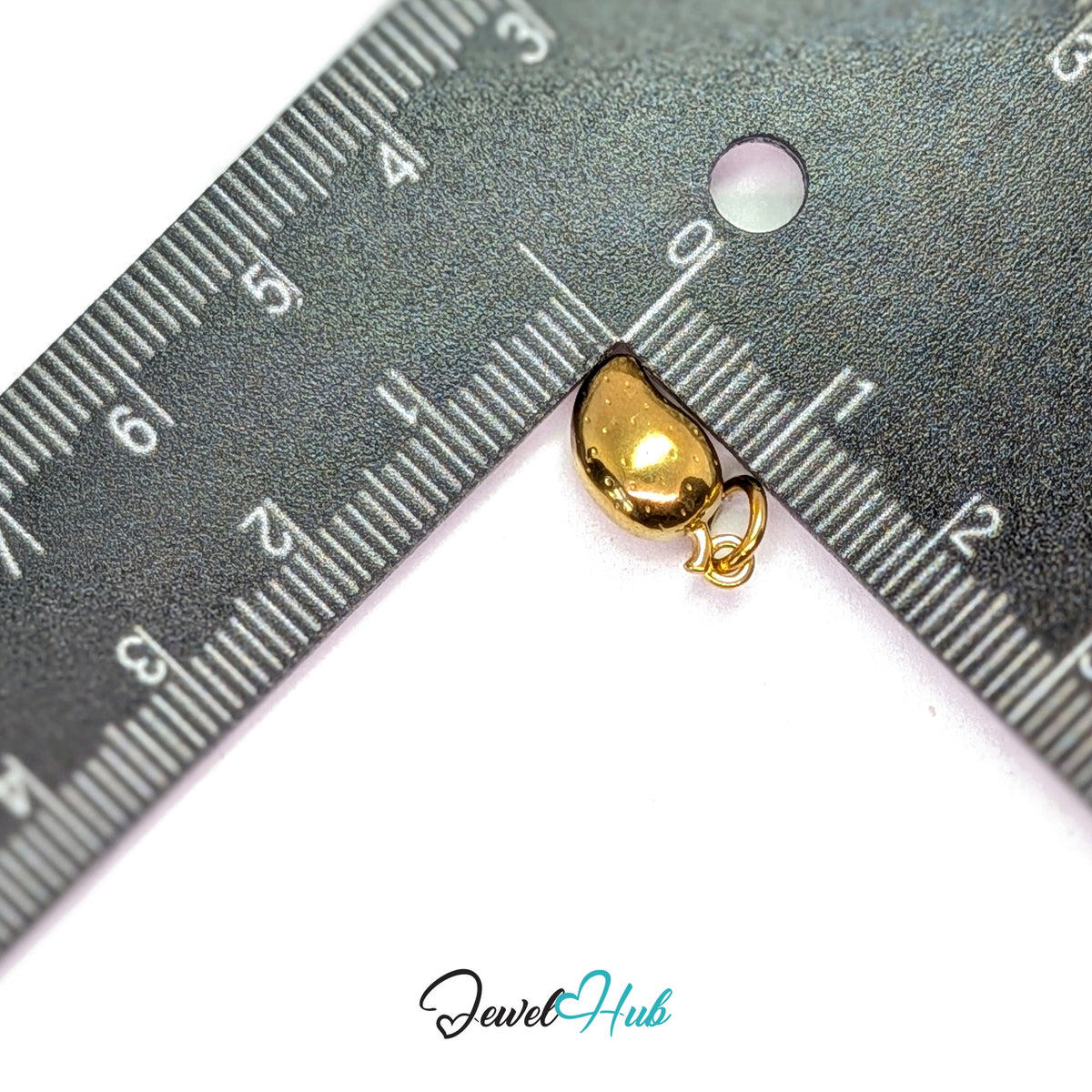 Mango charm measured against a ruler at 7.3mm wide by 14.7mm tall - JewelHub