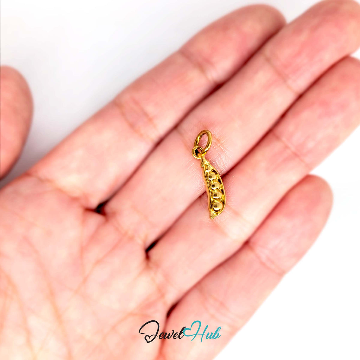 Pea pod charm held in a hand to show its size - JewelHub
