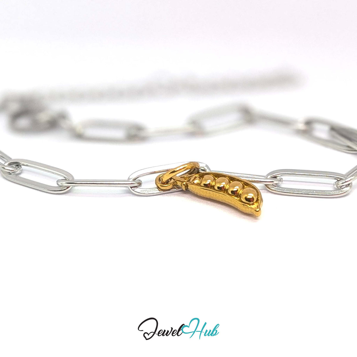 Gold-tone pea pod charm styled on a silver paperclip chain bracelet for a two-tone look - JewelHub