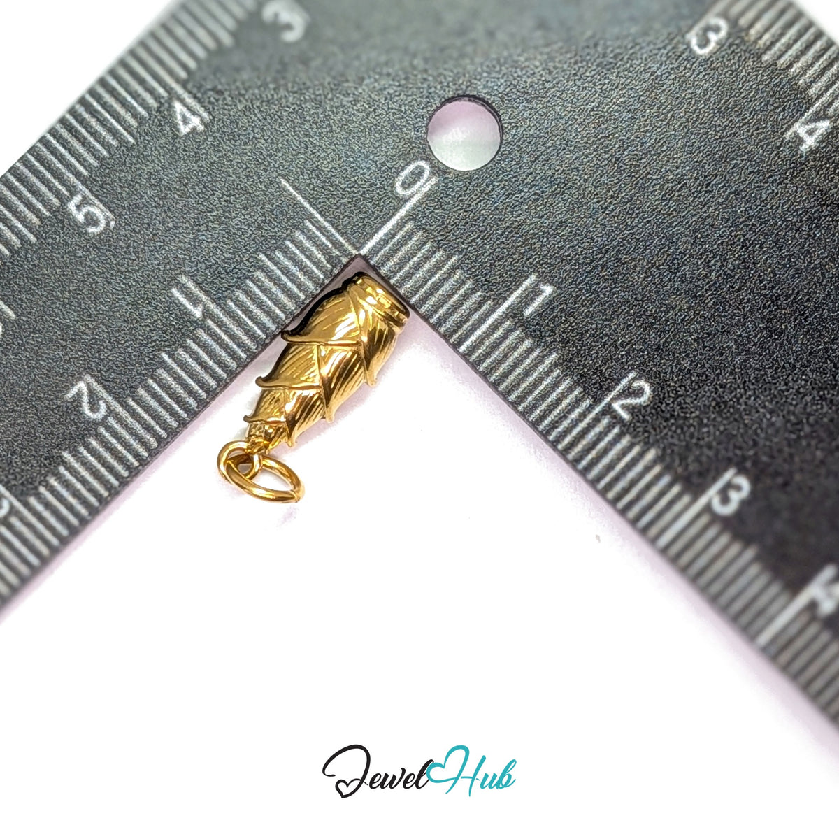 Corn in husk charm measured against a ruler at 7.7mm wide by 18.2mm tall - JewelHub